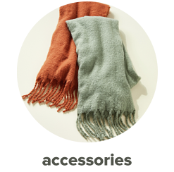 An orange and sage colored scarf with fringe. Shop accessories.