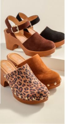 Black and brown clogs with an ankle strap and wooden base next to 2 slide on wooden clogs in camel and leopard print with silver studded accents.