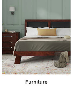 A bedroom with a bed and a night stand. Shop furniture.