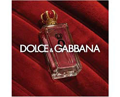 A perfume bottle on a red background. Shop Dolce and Gabbana. 