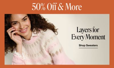 50% off and more. Layers for every moment. Shop sweaters. A woman wearing a white, pink and brown knitted sweater.