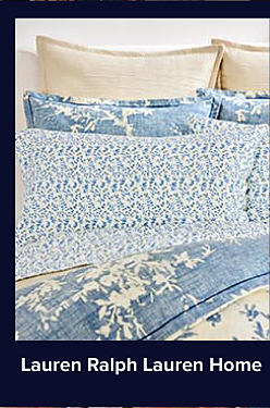 An image of a bed with blue and white bedding. Shop Lauren Ralph Lauren Home.