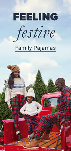 A family at a tree farm, all wearing matching pajama bottoms or sweaters. Feeling festive. Shop Family Pajamas. 