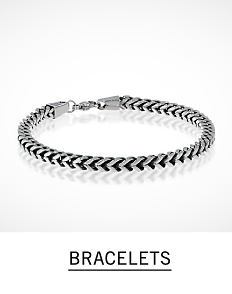 A braided silver tone men's bracelet. Shop men's bracelets. 