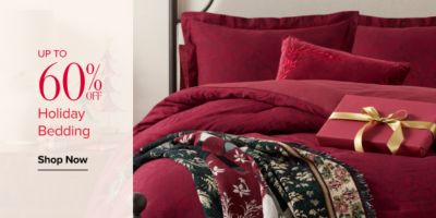 Up to 60% off holiday bedding. Shop now. Red bedding collection with wrapped gift.