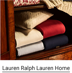 A collection of folded throw blankets in a variety of colors. Lauren Ralph Lauren Home.