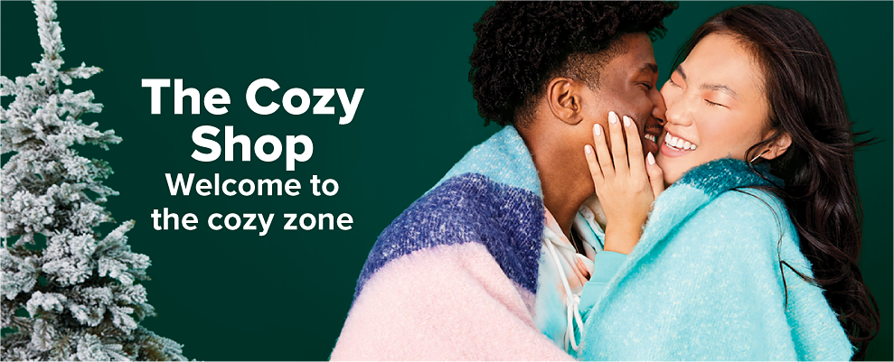 A man and a woman wrapped up in fuzzy blue throw blankets. The cozy shop. Welcome to the cozy zone. 