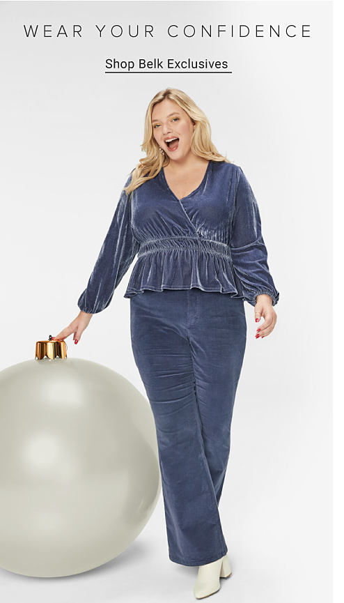 Woman wearing blue velvet top and bottom. Wearing your confidence. Shop Belk Exclusives.
