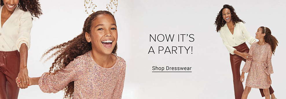 Image of a girl in a pink dress and antler headband pulling a woman by the arm. Now it's a party. Shop Dresswear. Image of a woman in brown pants and a white sweater smiling with a girl in a pink dress.