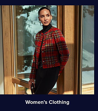 An image of a woman in a plaid-printed jacket and black turtleneck sweater. Shop women's clothing.