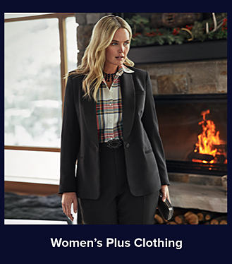 An image of a woman in a black suit jacket, a plaid-printed shirt, and a pair of black pants. Shop women's plus clothing.