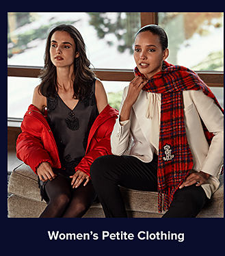 An image of a woman in a black V-neck dress with a red jacket sitting next to a woman in a white sweater with a red plaid scarf and black pants. Shop women's petite clothing.