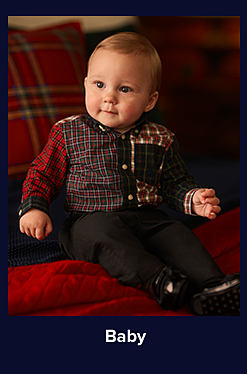 An image of a baby in a multi-printed button-down shirt and black pants. Shop baby clothing.