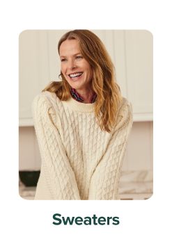 An image of a woman wearing a sweater. Sweaters.