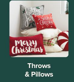 An image of a variety of holiday pillows. Throws and pillows.