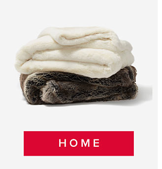 An image of a white fuzzy blanket, folded and stacked on top of a brown fuzzy blanket. Shop home. 