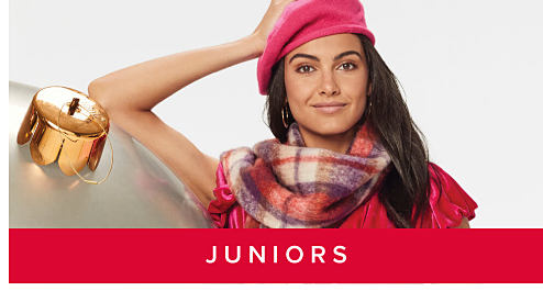 An image of a woman in a pink beret and a scarf. Shop juniors. 