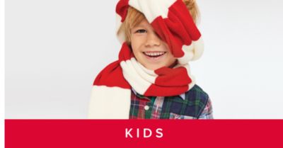 An image of a kid in a red and white scarf. Shop kids. 