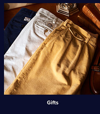 Three pairs of pants in khaki, stone and navy. Shop gifts.