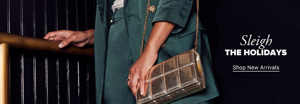 Image of someone holding a metallic quilted handbag. Sleigh the holidays. Shop new arrivals.