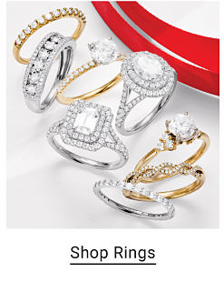 An image of eight gold and silver diamond rings. Shop rings.
