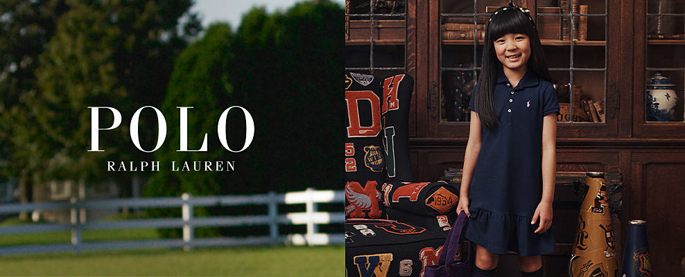 Polo Ralph Lauren. An image of a young girl in a navy blue shirtdress. Shop girl's clothing.