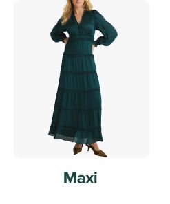 Woman wearing a green maxi dress. Maxi.