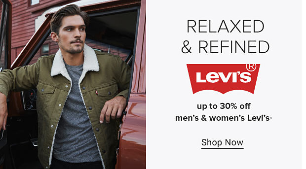 An image of a man wearing a green trucker jacket with a wool collar, dark denim and Converse shoes. Relaxed and refined. Levi's. Up to 30% off men's and women's Levi's. Shop now. 