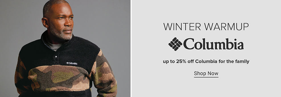 An image of a man in a black and camo fleece jacket. Winter Warmup. Columbia. Up to 25% off Columbia for the family. Shop now