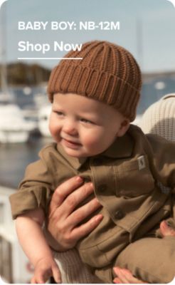 Baby boy: NB-12M. Shop now. A baby boy in a matching set and beanie.