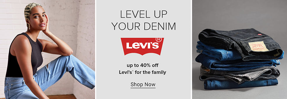 Image of a woman wearing a black tank top and light wash jeans. Level up your denim. Levi's logo. Up to 40% off Levi's for the family. Shop now. Stack of jeans.