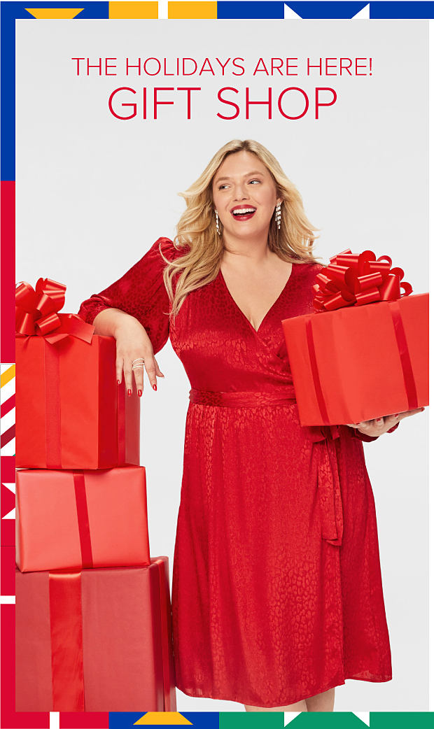 The holidays are here! Image of woman in red dress with gift boxes. The Gift Shop.