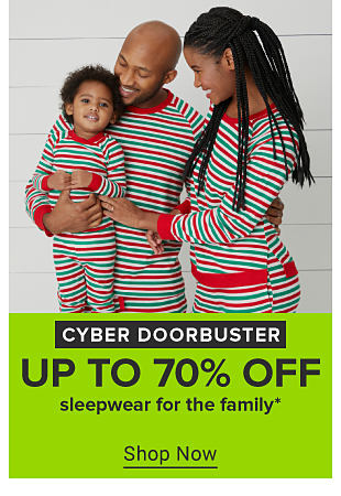 An image of a family in matching red Mickey pajamas. Cyber doorbuster. 70% off sleepwear for the family. Shop now 