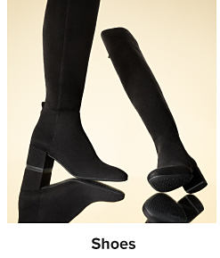 Two tall black boots. Shop shoes.