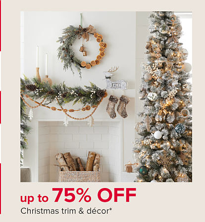 An image of a Christmas tree and decorated mantle. Up to 75% off Christmas trim & decor.