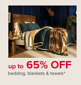 A bed with green bedding and a fake fur blanket. Up to 65% off bedding, blankets & towels.
