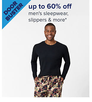 Doorbuster. Up to 60% off men's sleepwear, slippers & more. Image of a man wearing pajamas. Shop now.