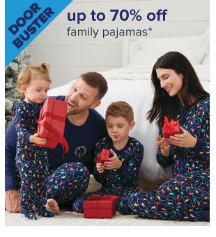 Doorbuster. Up to 70% off family pajamas. Image of a family wearing matching pajamas. Shop now.