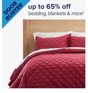 Doorbuster. Up to 65% off bedding, blankets & more. Image of a made bed. Shop now.