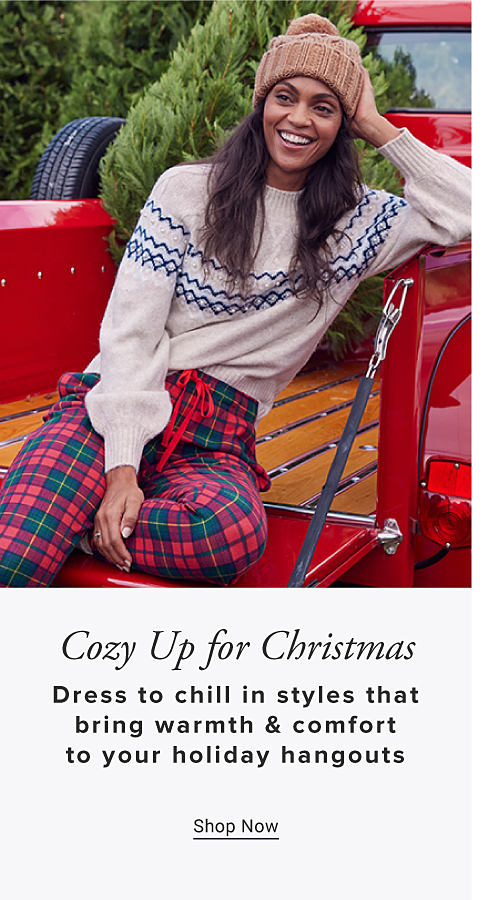 Image of woman in pajamas in a red truck Cozy Up for Christmas Dress to chill ins styles that bring warmth & comfort to your holiday hangouts Shop Now