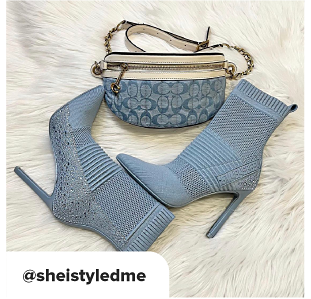 Blue boots with heels paired next to a blue and white Coach purse. At She I Styled Me. 