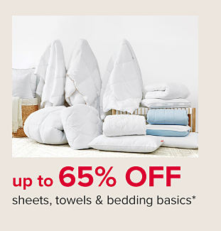 An assortment of white bedding and pillows. Up to 65% off sheets, towels and bedding basics. 