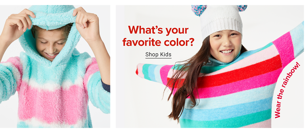 A girl with her hoodie up wears a sherpa that is blue and pink with white stripes. A girl in a striped turtle neck that is pink, red, blue and green. She wears a white beanie that has puffer balls on the side of it. Wear the rainbow! What's your favorite color? Shop kids. 