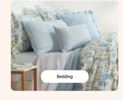 A bed with blue bedding. Shop bedding.