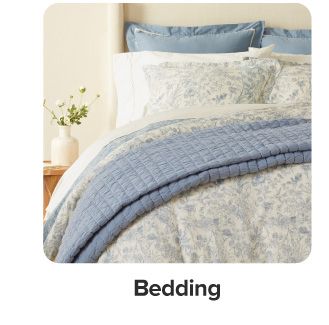 A bed with blue and white bedding. Shop bedding.