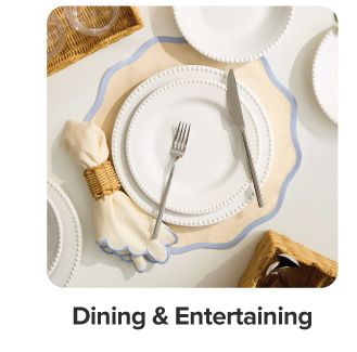 A table setting with a napkin, plates and silverware. Shop dining and entertainment.