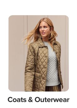 An image of a woman wearing a sweater and jacket. Shop coats and outerwear.