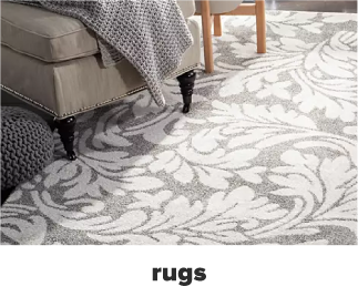 A grey rug with white patterns. Shop rugs