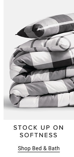 An image of a black and white plaid bedding set. Stock up on softness. Shop bed and bath.