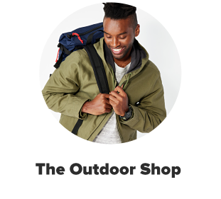 A man in a plaid shirt with a beige jacket. The outdoor shop. 